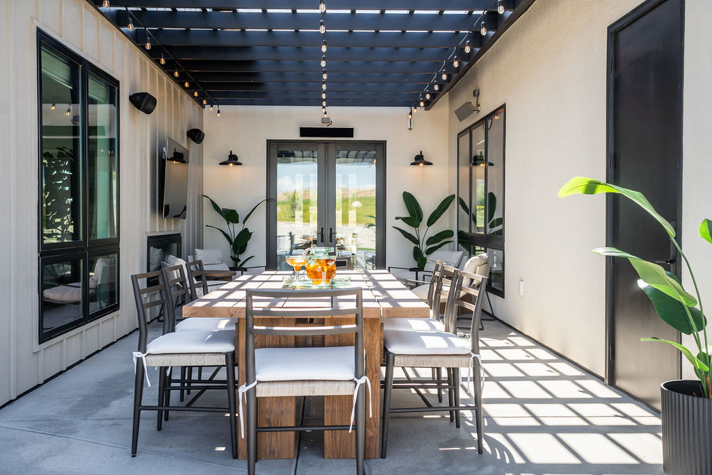 Indoor outdoor patio dining space with pergola lighting designed for modern lifestyle home