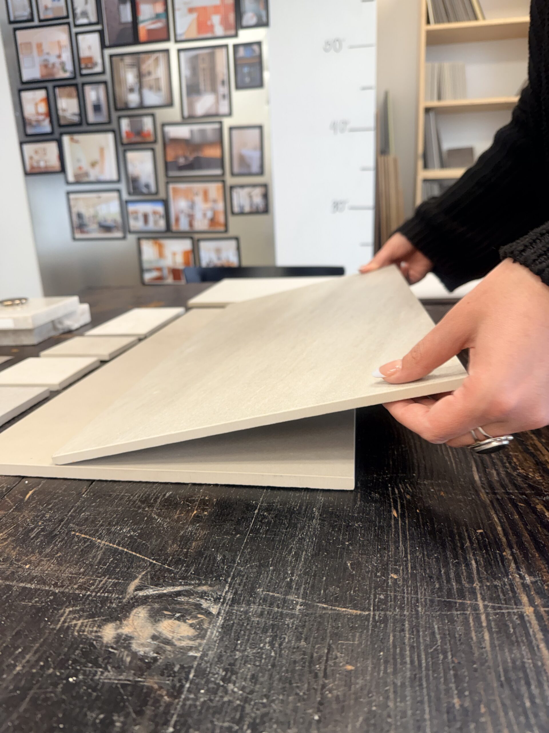 Designer selecting tile samples during home renovation pre-construction planning